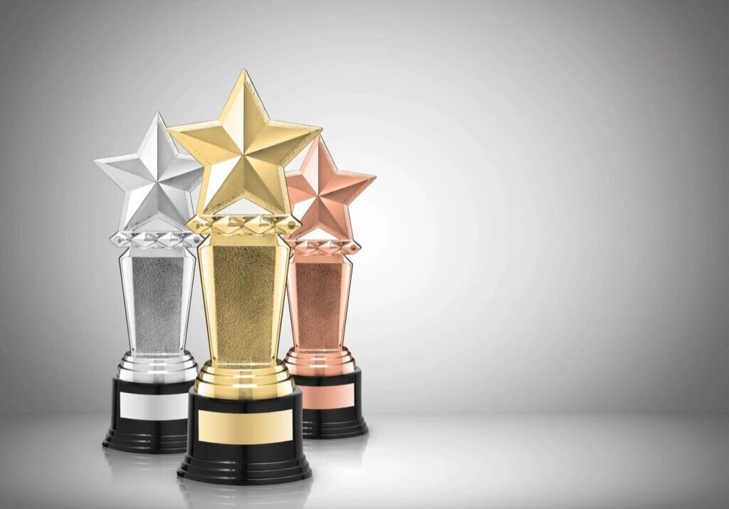 Three awards are shown with a star on top.